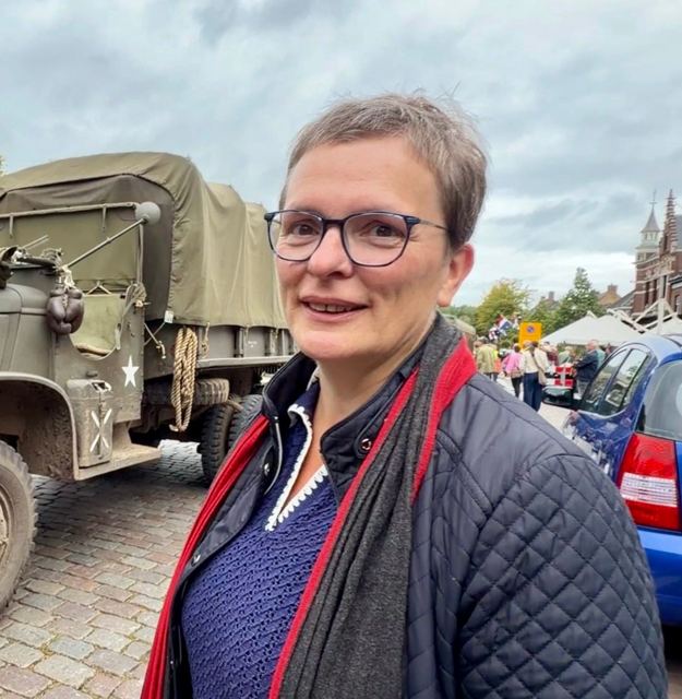 Hetty van den Tillaart beside a wartime truck